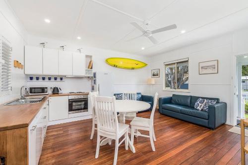 a kitchen and living room with a table and a couch at Ivys Beach House in North Haven