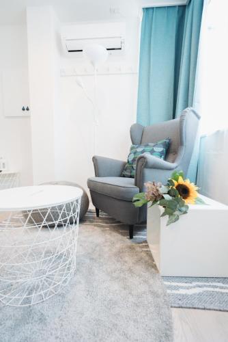 a living room with a chair and a table at Shinjuku Mermaid Apartment in Tokyo