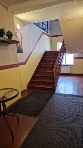 a staircase in a building with a table and a table at Pie Parka in Alūksne