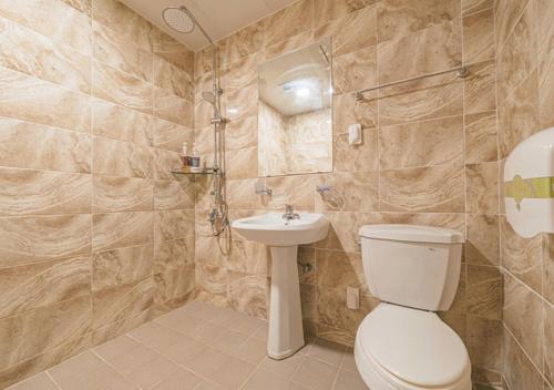 a bathroom with a toilet and a sink at Jeju Healing Resort in Jeju