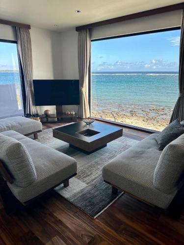 a living room with a view of the ocean at HERO VILLA ocean suite in Ishigaki Island