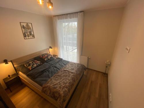 Ένα ή περισσότερα κρεβάτια σε δωμάτιο στο Apartament Calisia