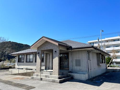a small house sitting on top of a parking lot at サンライズ日南 in Nichinan