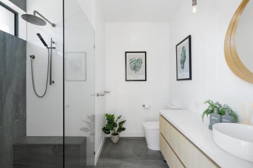 Un baño con ducha, inodoro y lavabo. en Oceanviews on Pearl, en Kingscliff