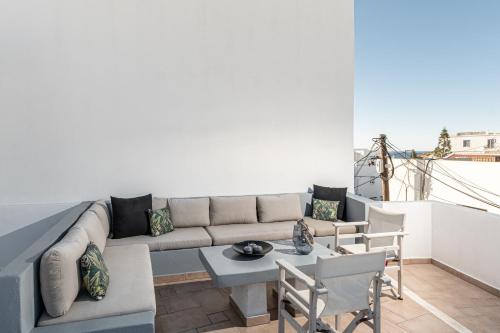 a living room with a couch and a table and chairs at Cozy Comfy Town House in Naxos Chora