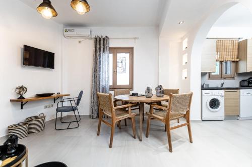 a kitchen and dining room with a table and chairs at Cozy Comfy Town House in Naxos Chora