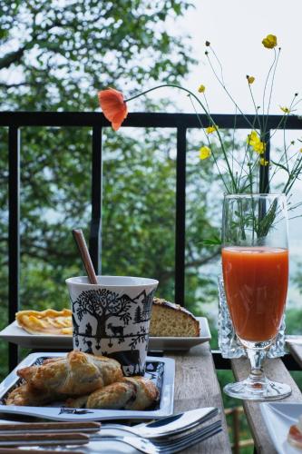 a table with a plate of food and a drink at La Masia Del Taulat Chambres d´Hôtes in Llo