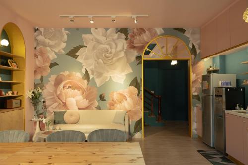 a living room with a flower mural on the wall at Manas B&B in Taitung City