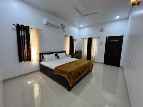 a bedroom with a bed in the middle of a room at iIRA Stays: Ocean Bliss (Sea View) in Alibaug