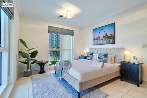 a bedroom with a bed and a large window at bnbmehomes - Great Value over looking Canal in Professional Apt - 303 in Dubai