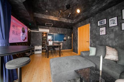 a living room with a couch and a table at LUCENT in Toyohira