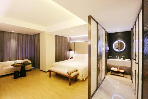 a hotel room with a bed and a bathroom at Atour S Hotel Chengdu Taikoo Li in Chengdu