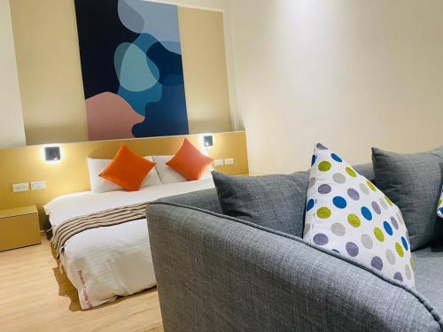 a living room with a bed and a couch at Beachcastle & Sea View Villa in Magong