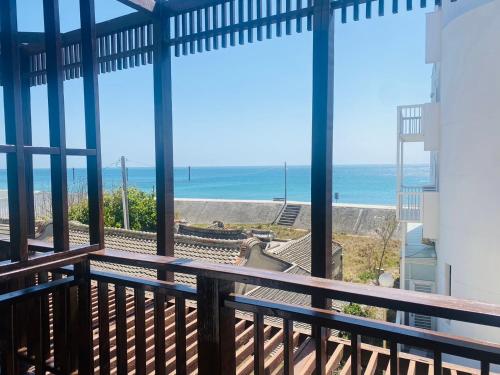 a balcony with a view of the ocean at Beachcastle & Sea View Villa in Magong