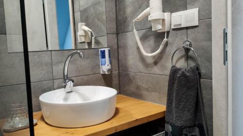 a bathroom with a white sink and a mirror at Bornemisza Kúria Wellness Resort in Tiszabecs