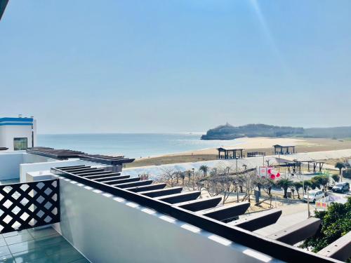 a view of the beach from the balcony of a building at Beachcastle & Sea View Villa in Magong