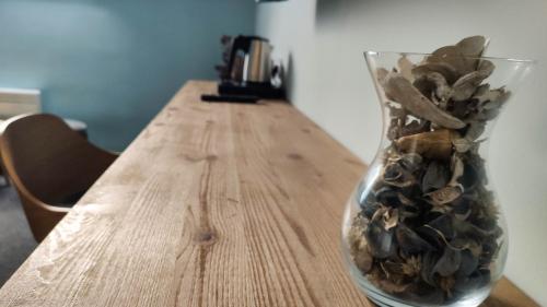 a vase filled with rocks sitting on a wooden table at Bornemisza Kúria Wellness Resort in Tiszabecs
