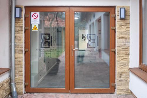 a wooden door with glass panels on a building at Bornemisza Kúria Wellness Resort in Tiszabecs
