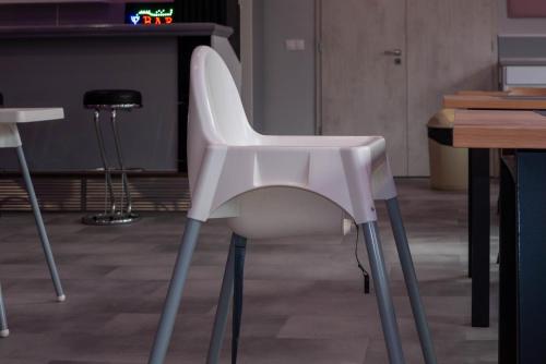 a white chair sitting in front of a table at Bornemisza Kúria Wellness Resort in Tiszabecs