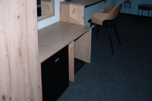 a wooden desk in a room with a chair at Bornemisza Kúria Wellness Resort in Tiszabecs