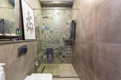 a bathroom with a shower and a toilet at Amani Luxury Apartments Nairobi in Nairobi