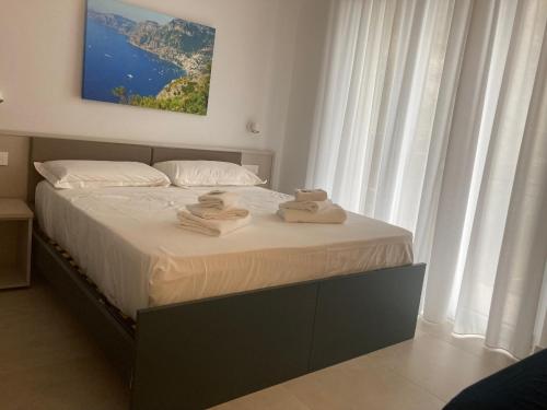 a bedroom with a bed with towels on it at Divina Holiday - Rooms in Maiori