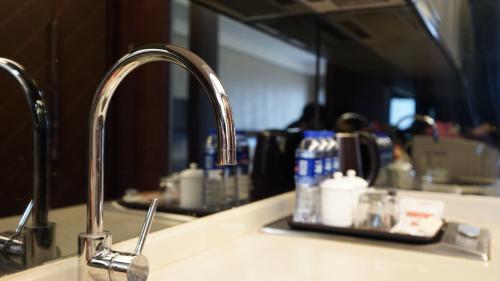 a kitchen sink with a faucet in a kitchen at Guangzhou City Inn Hotel Apartment Changgang in Guangzhou