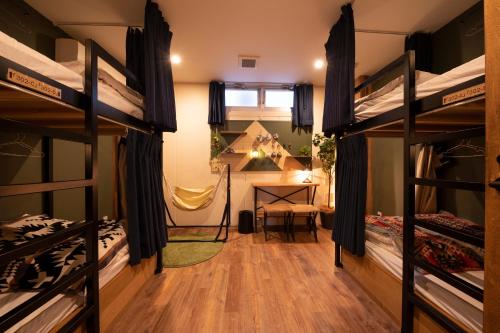a room with two bunk beds and a desk at Glamping Tokyo Asakusa in Tokyo
