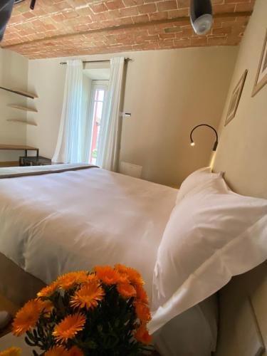 a bedroom with a bed with orange flowers on it at Tenuta Pizzone Wine Resort in Rivanazzano