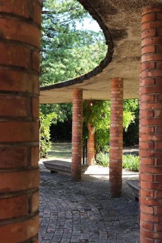 a pavilion with a bench in a park at Tenuta Pizzone Wine Resort in Rivanazzano