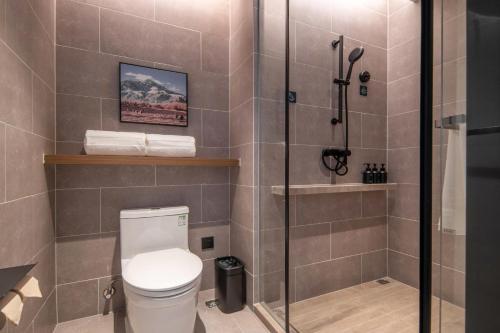 a bathroom with a toilet and a shower at Atour Hotel Zhuhai Jinwan Airport in Zhuhai