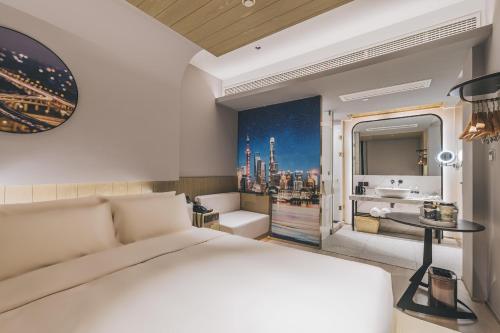 a bedroom with a large bed and a bathroom at Atour Light Hotel Shanghai East Nanjing Road 130 in Shanghai