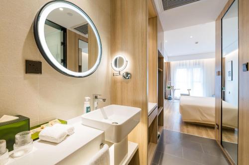 a bathroom with a sink and a mirror at Atour Hotel Shanghai Hongqiao Korea Street in Shanghai