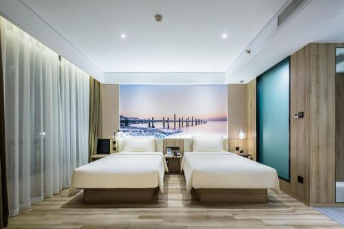 a hotel room with two beds and a pier at Atour Hotel Qingdao Fuzhou Road Sakura Town in Qingdao