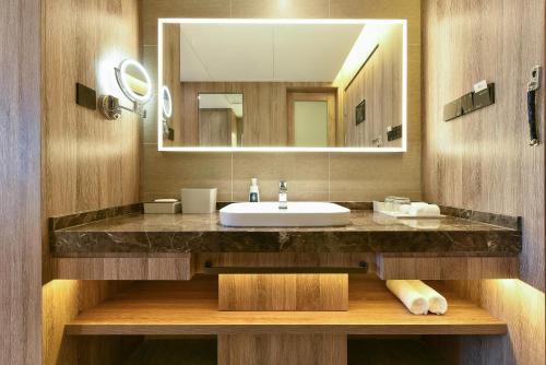 a bathroom with a sink and a mirror at Atour Hotel Beijing Chaoyang Park in Beijing