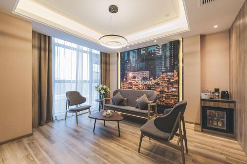 a living room with a couch and chairs and a table at Atour Hotel Chongqiang Jiangbei Airport in Chongqing