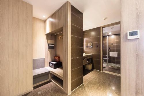 a bathroom with a toilet and a sink and a mirror at Atour S Hotel Chunxi Road Chengdu in Chengdu