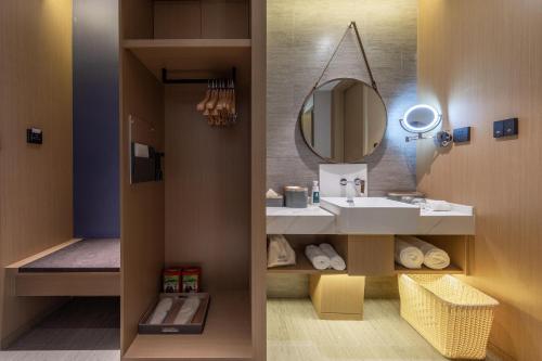 a bathroom with a sink and a mirror at Atour S Hotel Jinan Baotu Spring in Jinan