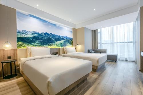 a hotel room with two beds and a large window at Atour Hotel Changsha International Covention Centre South Railway Station in Changsha