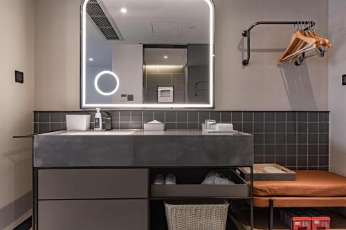 a bathroom with a sink and a mirror at Atour Light Hotel Chunxi Road Subway Station Taikoo Li Chengdu in Chengdu