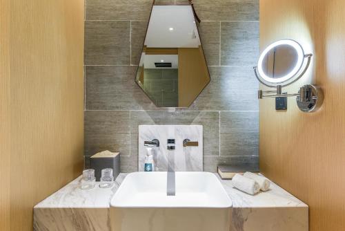 a bathroom with a sink and a mirror at Atour Hotel Beijing Linkong New International Exhibition Center in Shunyi