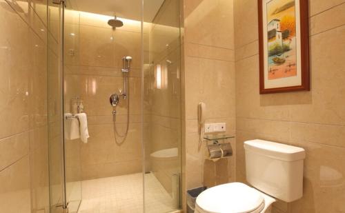 a bathroom with a glass shower with a toilet at Atour Hotel Wangfujing Ave Xinjiekou Nanjing in Nanjing