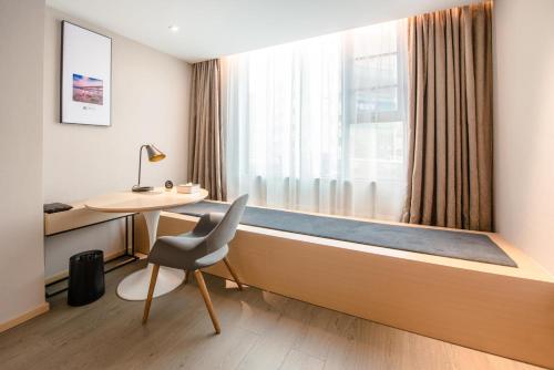 a room with a window with a desk and a chair at Atour Hotel Shenzhen Baoan International Airport in Bao'an