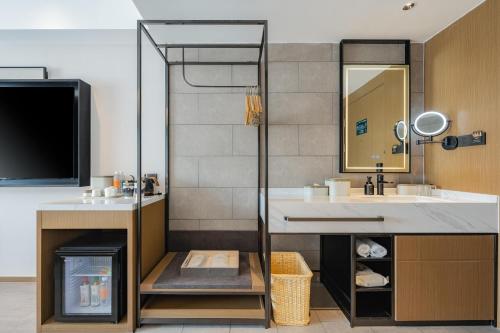 a bathroom with a sink and a mirror at Atour Hotel Qingdao Central Business District University of Science and Technology in Qingdao