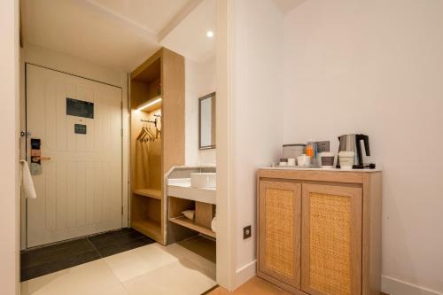 a bathroom with a sink and a white door at Atour X Hotel Shenzhen Airport Bao'an Yitian Plaza in Bao'an