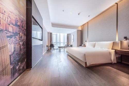 1 dormitorio con 1 cama grande y una pared grande en Atour S Shenzhen Nanshan en Shenzhen