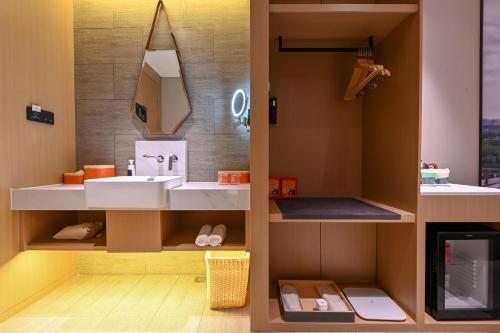 a bathroom with a sink and a mirror at Atour Hotel Changchun Automobile Development Zone in Changchun