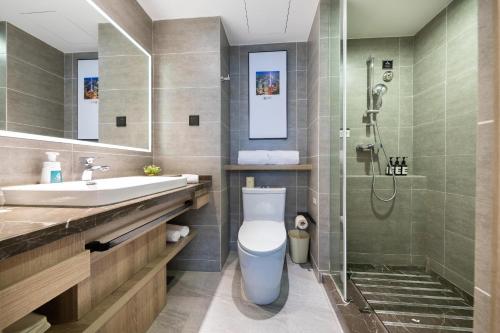 a bathroom with a toilet and a sink and a shower at Atour Hotel Shanghai Lujiazui Babaihan in Shanghai