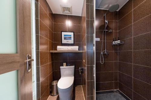 a bathroom with a toilet and a shower at Atour Hotel Jinan High-tech Wanda Plaza Tiancheng Road in Jinan