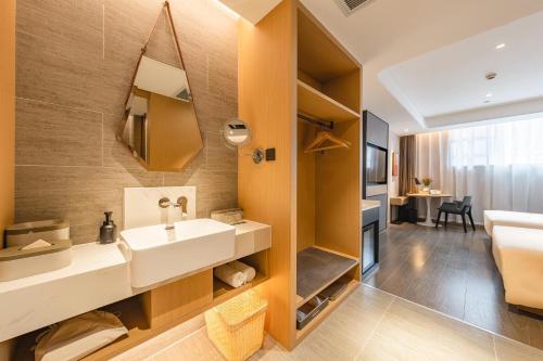 a bathroom with a sink and a mirror at Atour Hotel Guangzhou Zhujiang New Town Wuyangtun in Guangzhou